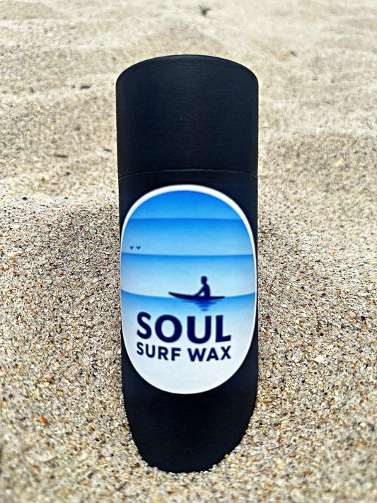 Soul Surf Wax tube standing in the sand